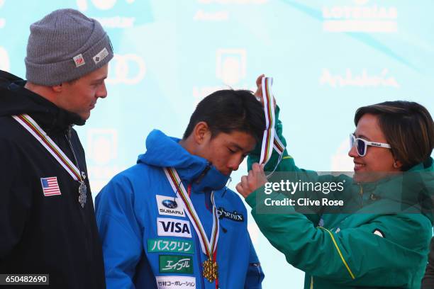 Ikuma Horishima of Japan is presented with his second gold medal with silver medallist Bradley Wilson of the United States after the Men's Dual...