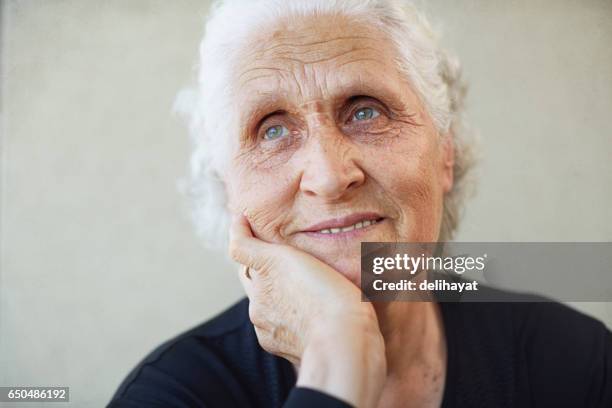 senior woman lost in thoughts - studio shot lonely woman stock pictures, royalty-free photos & images