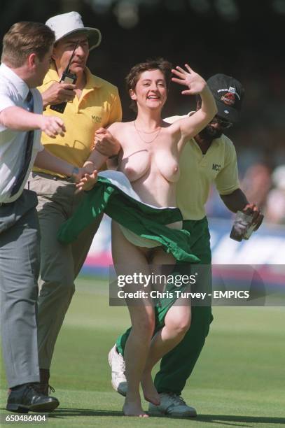 Woman streaker at Lords is escorted off the pitch