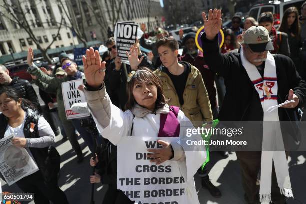 Protesters pray in front of the Immigration and Customs Enforcement , office at the U.S. Federal building during a Solidarity Rally Against...