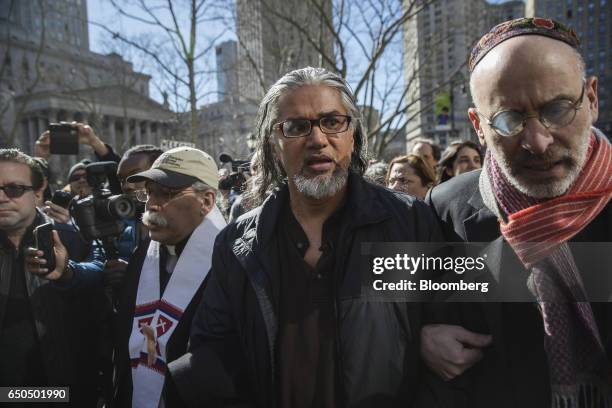 Immigration activist Ravi Ragbir, center, arrives at a check-in with Immigration and Customs Enforcement at the Jacob K. Javits Federal Building in...