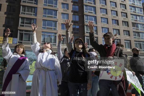 Demonstrators participate in a prayer while accompanying immigration activist Ravi Ragbir, not pictured, to a check-in with Immigration and Customs...