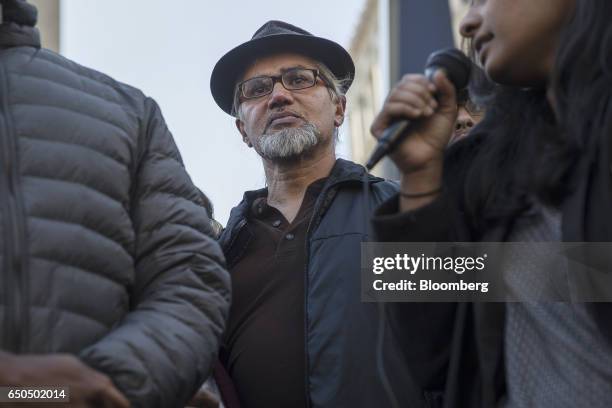 Immigration activist Ravi Ragbir, center, listens during a rally after a check-in with Immigration and Customs Enforcement at the Jacob K. Javits...