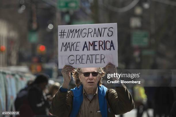 Demonstrator holds a sign while marching to accompany immigration activist Ravi Ragbir, not pictured, to a check-in with Immigration and Customs...