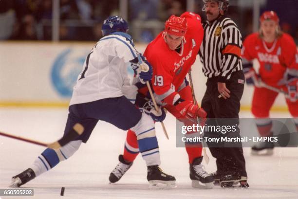 Alexei Yashin of Russia charges past Finland's Kimmo Timonen