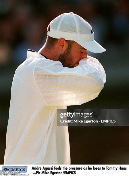 Andre Agassi wipes his mouth on his sleeve