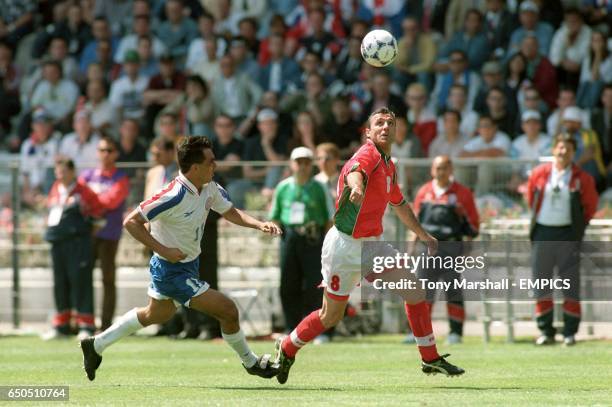 Pedro Sarabia of Paraguay chases after Hristo Stoichkov of Bulgaria