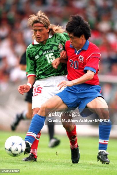 Mexico's Luis Hernandez gets pushed by South Korea's Myung Bo Hong