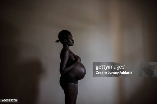 Ayak, from Malakal, in South Sudan, poses for a portrait in a safe house in Uganda, December 8, 2015. Ayak grew up in Kakuma refugee camp in Kenya,...