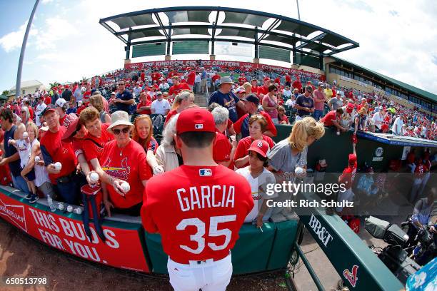 Greg Garcia of the St. Louis Cardinal signs autographes before a spring training game against the Houston Astros at Roger Dean Stadium on March 9,...