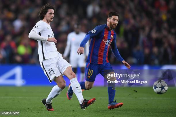 Adrien Rabiot of PSG in action with Lionel Messi during the UEFA Champions League Round of 16 second leg match between FC Barcelona and Paris...