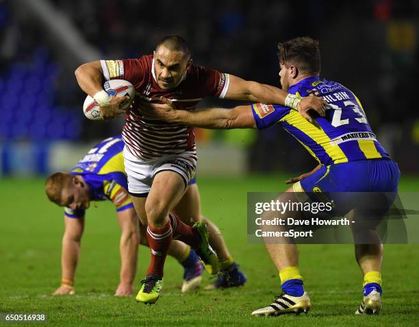 Wigan Warriors' Thomas Leuluai is tackled by Warrington Wolves' Joe Philbin during the Betfred Super League Round 4 match between Warrington Wolves...