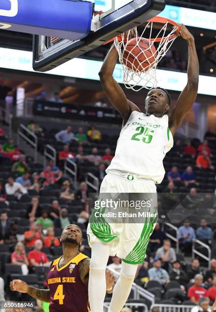 Chris Boucher of the Oregon Ducks dunks ahead of Torian Graham of the Arizona State Sun Devils during a quarterfinal game of the Pac-12 Basketball...