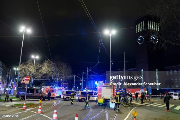 Police and emergency workers stand outside the main railway station following what police described as an axe attack on March 9, 2017 in Dusseldorf,...