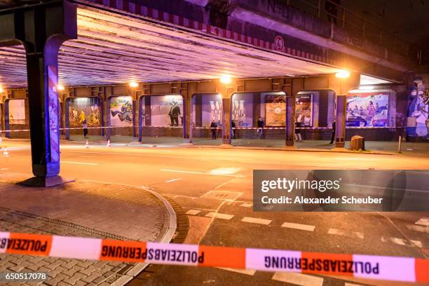 Police and emergency workers stand outside the main railway station following what police described as an axe attack on March 9, 2017 in Dusseldorf,...