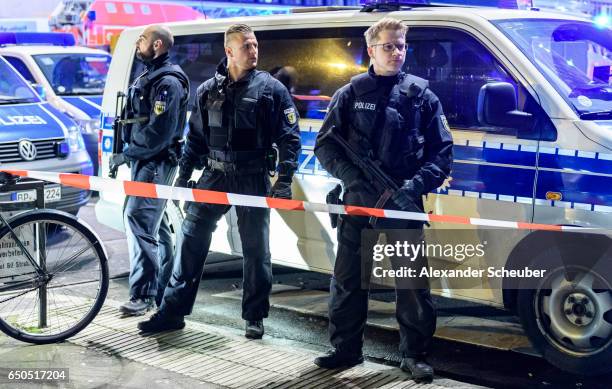 Police and emergency workers stand outside the main railway station following what police described as an axe attack on March 9, 2017 in Dusseldorf,...