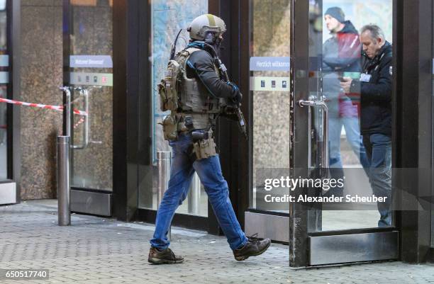 Police and emergency workers stand outside the main railway station following what police described as an axe attack on March 9, 2017 in Dusseldorf,...