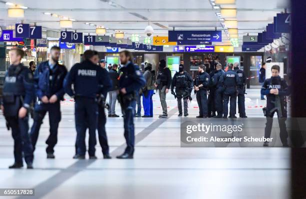 Police and emergency workers stand outside the main railway station following what police described as an axe attack on March 9, 2017 in Dusseldorf,...