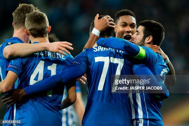 Genk's players celebrate after scoring a goal during the UEFA Europa League round of 16 football match between KAA Gent and KRC Genk in Gent on March...