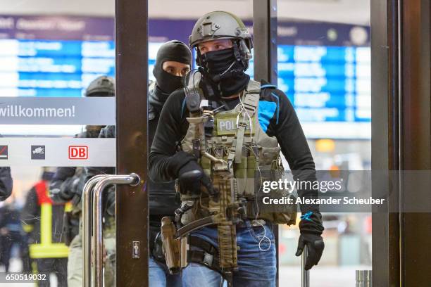 Police and emergency workers stand outside the main railway station following what police described as an axe attack on March 9, 2017 in Dusseldorf,...