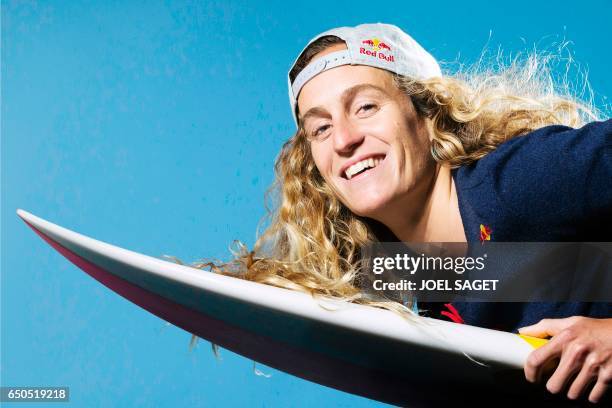 French surfer Justine Dupont poses during a photo session in Paris on March 8, 2017. / AFP PHOTO / JOEL SAGET