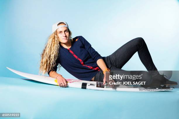 French surfer Justine Dupont poses during a photo session in Paris on March 8, 2017. / AFP PHOTO / JOEL SAGET