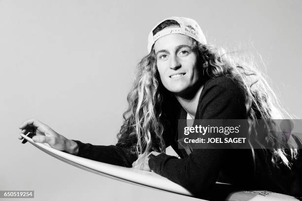 French surfer Justine Dupont poses during a photo session in Paris on March 8, 2017. / AFP PHOTO / JOEL SAGET