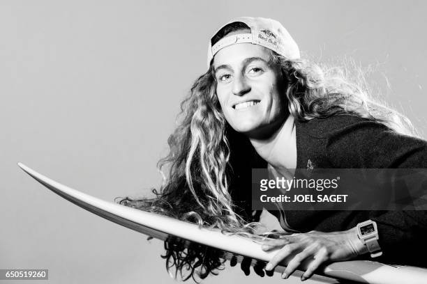French surfer Justine Dupont poses during a photo session in Paris on March 8, 2017. / AFP PHOTO / JOEL SAGET