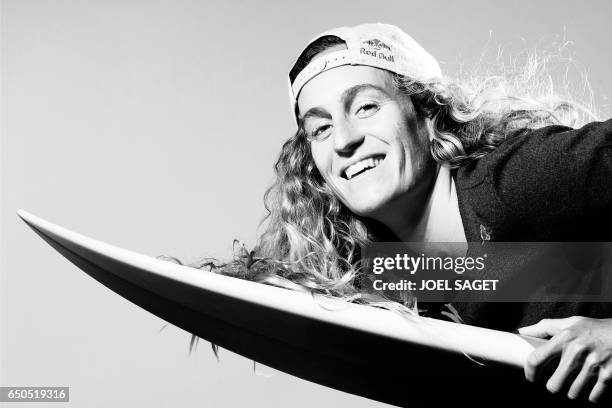 French surfer Justine Dupont poses during a photo session in Paris on March 8, 2017. / AFP PHOTO / JOEL SAGET