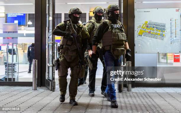 Police and emergency workers stand outside the main railway station following what police described as an axe attack on March 9, 2017 in Dusseldorf,...