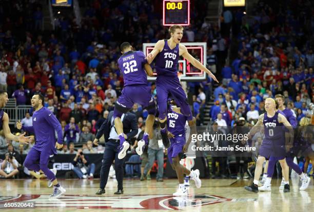 Vladimir Brodziansky and Karviar Shepherd of the TCU Horned Frogs celebrate as the Horned Frogs defeat the Kansas Jayhawks 85-82 to win the...
