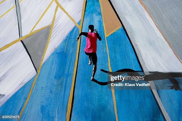 male athlete sprinting, shot from above - design sprint stock pictures, royalty-free photos & images