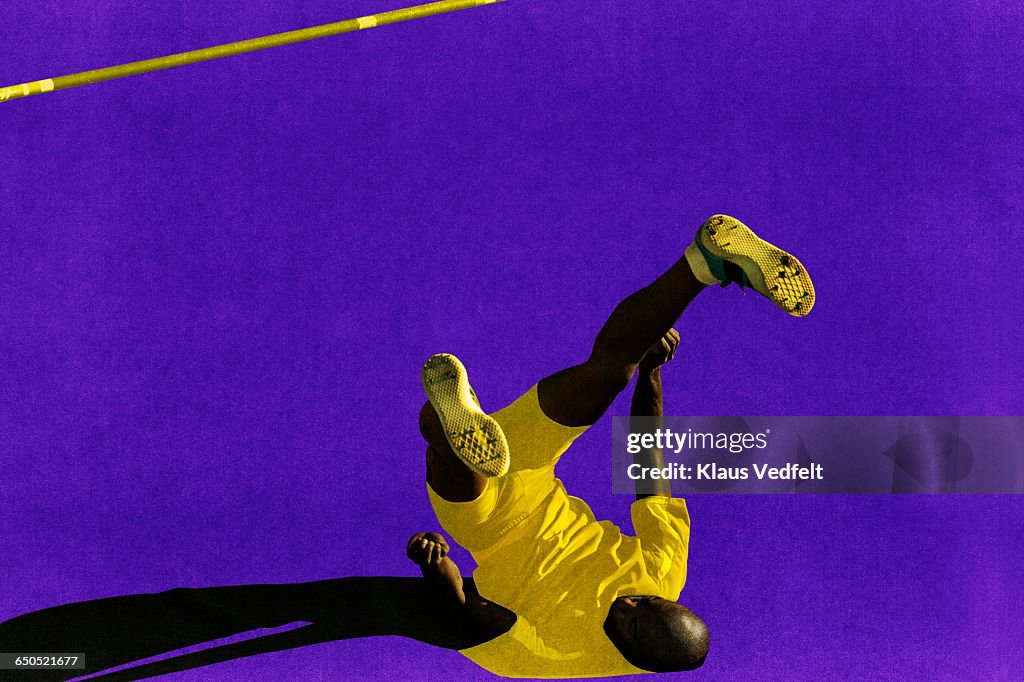 Male athlete landing after highjump