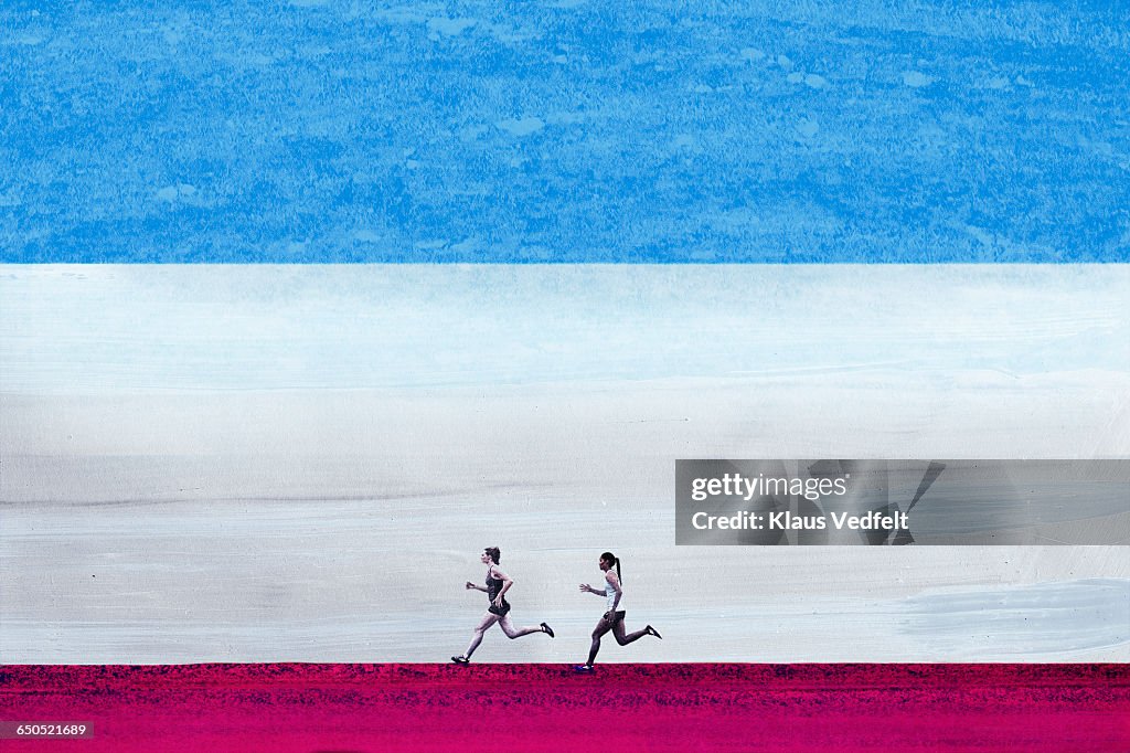 Female athletes running in big graphic space