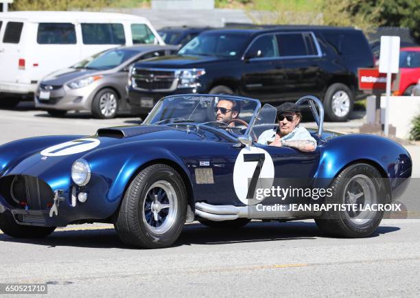 Veteran French rocker Johnny Hallyday steps out for lunch with French singer Maxim Nucci, aka Yodelice, in Malibu, California, on March 9, 2017. /...