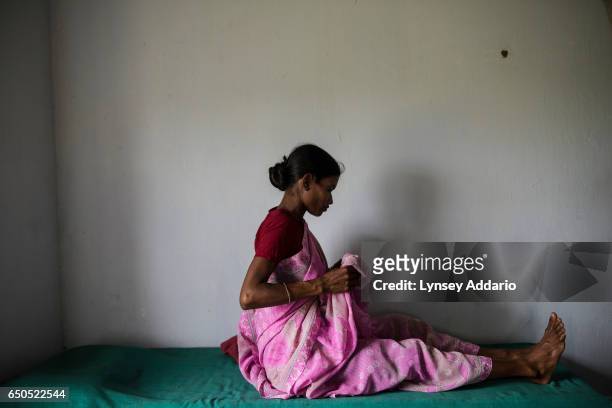 Anjita Barla who is seven months pregnant with her second child, receives a checkup from a midwife at a health clinic in Tinkharia tea garden in the...