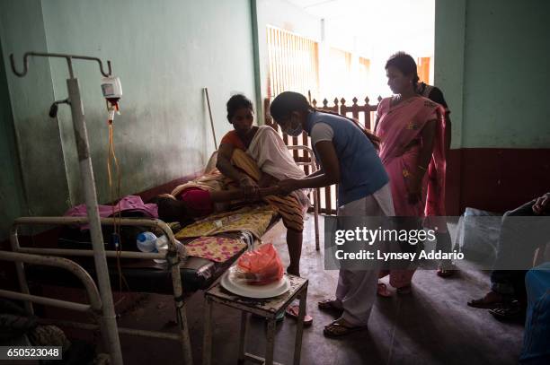 Pokhili, a Nazdeek activist who works to ensure women's maternal rights are met, accompanies Anita to the Anganwari center in Soloni Bongali village...