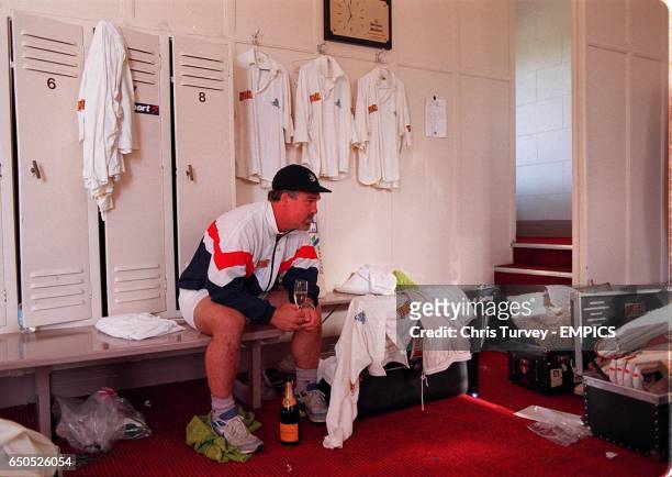 England's Mike Gatting relaxes in the Adelaide Oval dressing room with a bottle of champagne after scoring a century