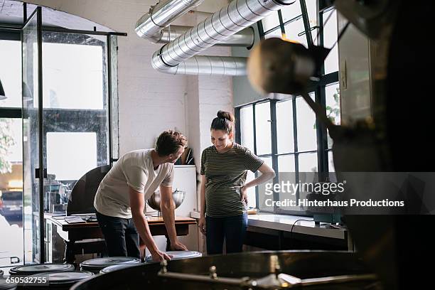 coffee roaster and female apprentice - business courage stock pictures, royalty-free photos & images
