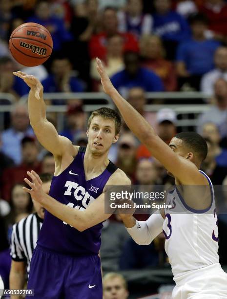 Vladimir Brodziansky of the TCU Horned Frogs passes as Landen Lucas of the Kansas Jayhawks defends during the quarterfinal game of the Big 12...