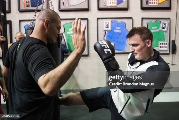 Ty Dillon, driver of the GEICO Chevrolet in the Monster Energy NASCAR Cup Series trains with Cain Velasquez during the UFC/NASCAR Cross-Training...