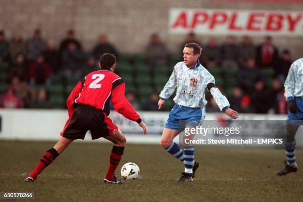 Lincoln City's Paul Miller defends against the attack of Stevenage Borough's Steve Berry