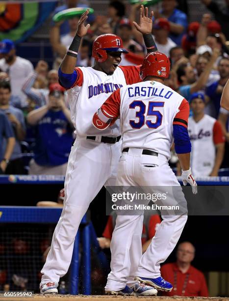 Welington Castillo is congratulated by Gregory Polanco of the Dominican Republic after hitting a two run home run during a Pool C game of the 2017...