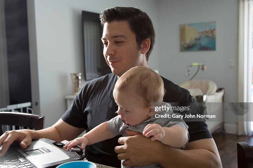 Baby Computer Work Dad Looking After Baby Working On Computer High-Res Stock Photo - Getty ...