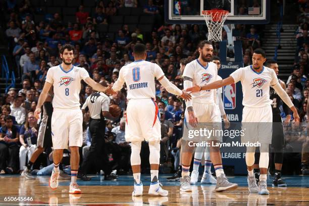 Russell Westbrook, Alex Abrines and Andre Roberson of the Oklahoma City Thunder high five each other during the game against the San Antonio Spurs on...