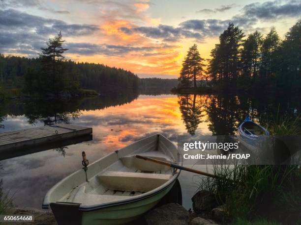 boat moored in lake - view of boats moored at jetty in calm lake stock pictures, royalty-free photos & images