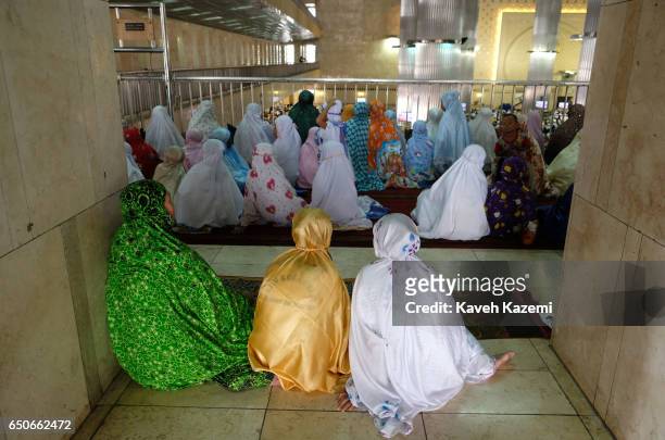 Muslim women dressed in colorful dresses and veils seen during Friday Prayer ceremony on a balcony allocated for females in Istiqlal Mosque on...