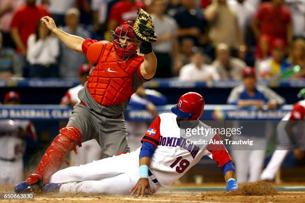 Jose Bautista of Team Dominican Republic is tagged out by George Kottaras of Team Canada at home plate during to Game 1 of Pool C of the 2017 World...