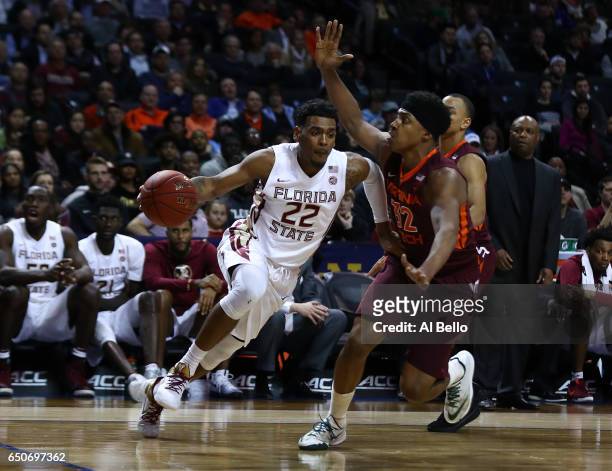 Xavier Rathan-Mayes of the Florida State Seminoles drives against Zach LeDay of the Virginia Tech Hokies during the Quarterfinals of the ACC...