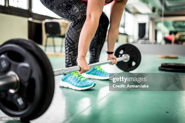 picking up the barbell - deadlift stock pictures, royalty-free photos & images